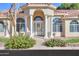 Inviting front entrance with a white door, columns, and lush landscaping at 1223 E Clearview Dr, Casa Grande, AZ 85122