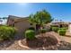 Landscaped front yard with desert landscaping and trees at 14766 W Piccadilly Rd, Goodyear, AZ 85395