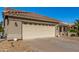 House exterior featuring a two-car garage and well-maintained landscaping at 14766 W Piccadilly Rd, Goodyear, AZ 85395