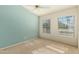 Bright bedroom with carpet flooring, ceiling fan, and dual pane windows at 14766 W Piccadilly Rd, Goodyear, AZ 85395