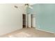 Bedroom with carpet flooring, ceiling fan, and access to bathroom at 14766 W Piccadilly Rd, Goodyear, AZ 85395