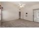 Bright bedroom with ceiling fan and walk-in closet at 14766 W Piccadilly Rd, Goodyear, AZ 85395