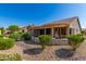 Landscaped backyard with covered patio and pebble stone at 14766 W Piccadilly Rd, Goodyear, AZ 85395