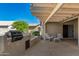 Outdoor kitchen with built-in grill and seating area at 14766 W Piccadilly Rd, Goodyear, AZ 85395