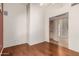 Bedroom with wood flooring and access to hallway and kitchen at 14766 W Piccadilly Rd, Goodyear, AZ 85395