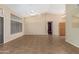 Open living room with tile floor and view of entryway and kitchen at 14766 W Piccadilly Rd, Goodyear, AZ 85395