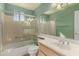 Bathroom with shower/tub combo, vanity sink, and tiled walls at 14766 W Piccadilly Rd, Goodyear, AZ 85395
