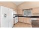 Bright kitchen with granite countertops and white appliances at 14766 W Piccadilly Rd, Goodyear, AZ 85395