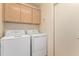 Laundry room with washer, dryer, and upper cabinets at 14766 W Piccadilly Rd, Goodyear, AZ 85395