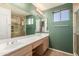 Bathroom with double vanity and large mirror at 14766 W Piccadilly Rd, Goodyear, AZ 85395