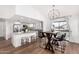 Dining area with a stylish table and chandelier, adjacent to the kitchen at 7322 E Greenway St, Mesa, AZ 85207