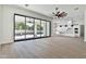Open living space showcasing sliding doors to the outdoors and a kitchen view at 2041 N Orchard --, Mesa, AZ 85213