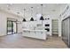 Bright kitchen featuring white cabinetry, an island, and a view to the backyard at 2041 N Orchard --, Mesa, AZ 85213