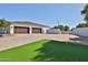 Two-car garage with paver driveway and artificial turf front yard at 2041 N Orchard --, Mesa, AZ 85213
