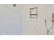 Modern shower with marble tile, built-in shelves, and rainfall shower head at 2041 N Orchard --, Mesa, AZ 85213
