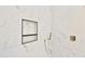 Modern shower with marble tile and built-in shelving at 2041 N Orchard --, Mesa, AZ 85213