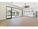 Spacious living area with sliding doors opening to a patio and kitchen views at 2041 N Orchard --, Mesa, AZ 85213