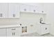 Clean laundry room with white cabinets, quartz countertops, and patterned tile floor at 2041 N Orchard --, Mesa, AZ 85213