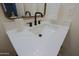 Bathroom vanity with single sink, quartz countertop and modern faucet at 10952 W Tropicana Cir, Sun City, AZ 85351