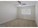 Bright bedroom featuring carpet flooring and a window with blinds at 10952 W Tropicana Cir, Sun City, AZ 85351