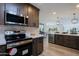 Updated kitchen, stainless steel appliances, and ample wood cabinetry at 10952 W Tropicana Cir, Sun City, AZ 85351