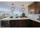 Eat-in kitchen with breakfast bar, modern fixtures, and golf course view at 10952 W Tropicana Cir, Sun City, AZ 85351