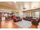 Open living space with leather sofas, hardwood floors, and views into a well-equipped kitchen at 3105 E Fruitvale Ct, Gilbert, AZ 85297