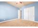 Blue walls and neutral carpet create a relaxing atmosphere in this bedroom at 3105 E Fruitvale Ct, Gilbert, AZ 85297