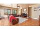 Relaxing living room with leather furniture, hardwood floors, a fireplace, and large windows at 3105 E Fruitvale Ct, Gilbert, AZ 85297