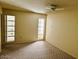 Bright bedroom with window access to patio at 10202 W Edgewood Dr, Sun City, AZ 85351