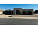 Mid-century modern home with single-car garage and mature landscaping at 10202 W Edgewood Dr, Sun City, AZ 85351