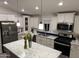 Bright kitchen features an island, stainless steel appliances, and white cabinets at 9302 E Broadway. -- # 147, Mesa, AZ 85208