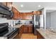 Modern kitchen with stainless steel appliances and wood cabinets at 3813 E Sierrita Rd, San Tan Valley, AZ 85143