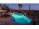 Inviting pool with a tranquil desert backdrop at night at 9215 E Red Lawrence Dr, Scottsdale, AZ 85262