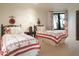 Bedroom with two twin beds and red and white quilt at 9215 E Red Lawrence Dr, Scottsdale, AZ 85262