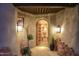 Unique entryway with arched wooden door at 9215 E Red Lawrence Dr, Scottsdale, AZ 85262