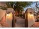 Ornate wooden gate opens to a stone pathway at 9215 E Red Lawrence Dr, Scottsdale, AZ 85262