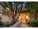 Elegant entryway with a wooden door, stone pathway, and mature trees at 9215 E Red Lawrence Dr, Scottsdale, AZ 85262