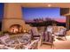 Elegant patio with fireplace and seating, scenic sunset view at 9215 E Red Lawrence Dr, Scottsdale, AZ 85262