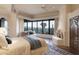 Relaxing main bedroom with fireplace, sitting area, and stunning mountain views at 9215 E Red Lawrence Dr, Scottsdale, AZ 85262