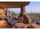 Outdoor fireplace and seating area on the patio with scenic views at 9215 E Red Lawrence Dr, Scottsdale, AZ 85262