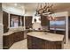 Spacious kitchen features an island, stainless steel appliances, and dark wood cabinets at 9215 E Red Lawrence Dr, Scottsdale, AZ 85262