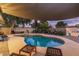 Stunning kidney shaped pool with patio furniture and shade structure at 8325 E Crestwood Way, Scottsdale, AZ 85250