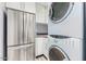 Laundry room with stacked washer and dryer at 8325 E Crestwood Way, Scottsdale, AZ 85250