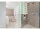 Modern bathroom with glass block shower, soaking tub, and double sinks at 8325 E Crestwood Way, Scottsdale, AZ 85250