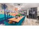 Modern dining area with a long wooden table and desert-themed wall art at 8325 E Crestwood Way, Scottsdale, AZ 85250