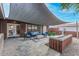 Modern patio with fire pit and comfortable seating area during the day at 8325 E Crestwood Way, Scottsdale, AZ 85250