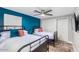 Bedroom with two twin beds and teal accent wall at 8325 E Crestwood Way, Scottsdale, AZ 85250