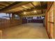 Covered carport with concrete flooring and lighted ceiling at 8325 E Crestwood Way, Scottsdale, AZ 85250