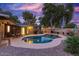 Inviting kidney shaped pool with surrounding gravel and patio furniture at 8325 E Crestwood Way, Scottsdale, AZ 85250